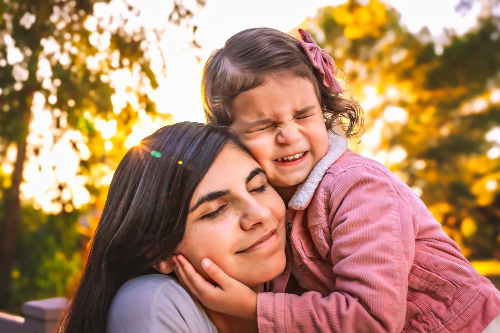 mom and daughter embracing during a sunset fall family session in the Central Valley.