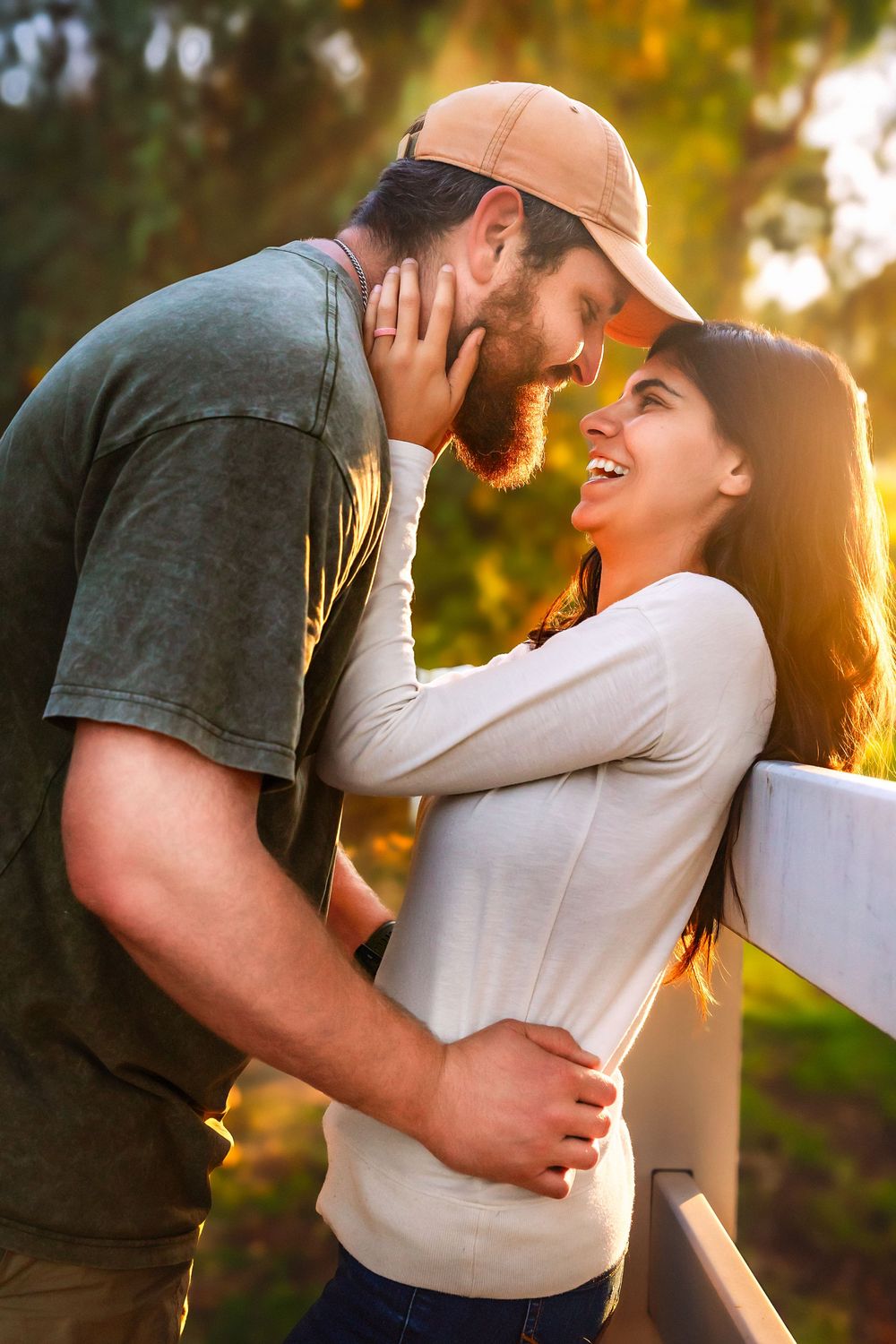 Parents embracing during a sunset fall family session in the Central Valley.