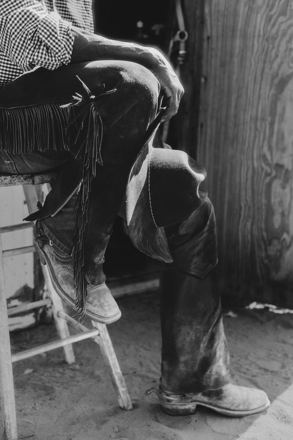 Vintage black and white photo showing close-up details of western boots and jeans on dancers.