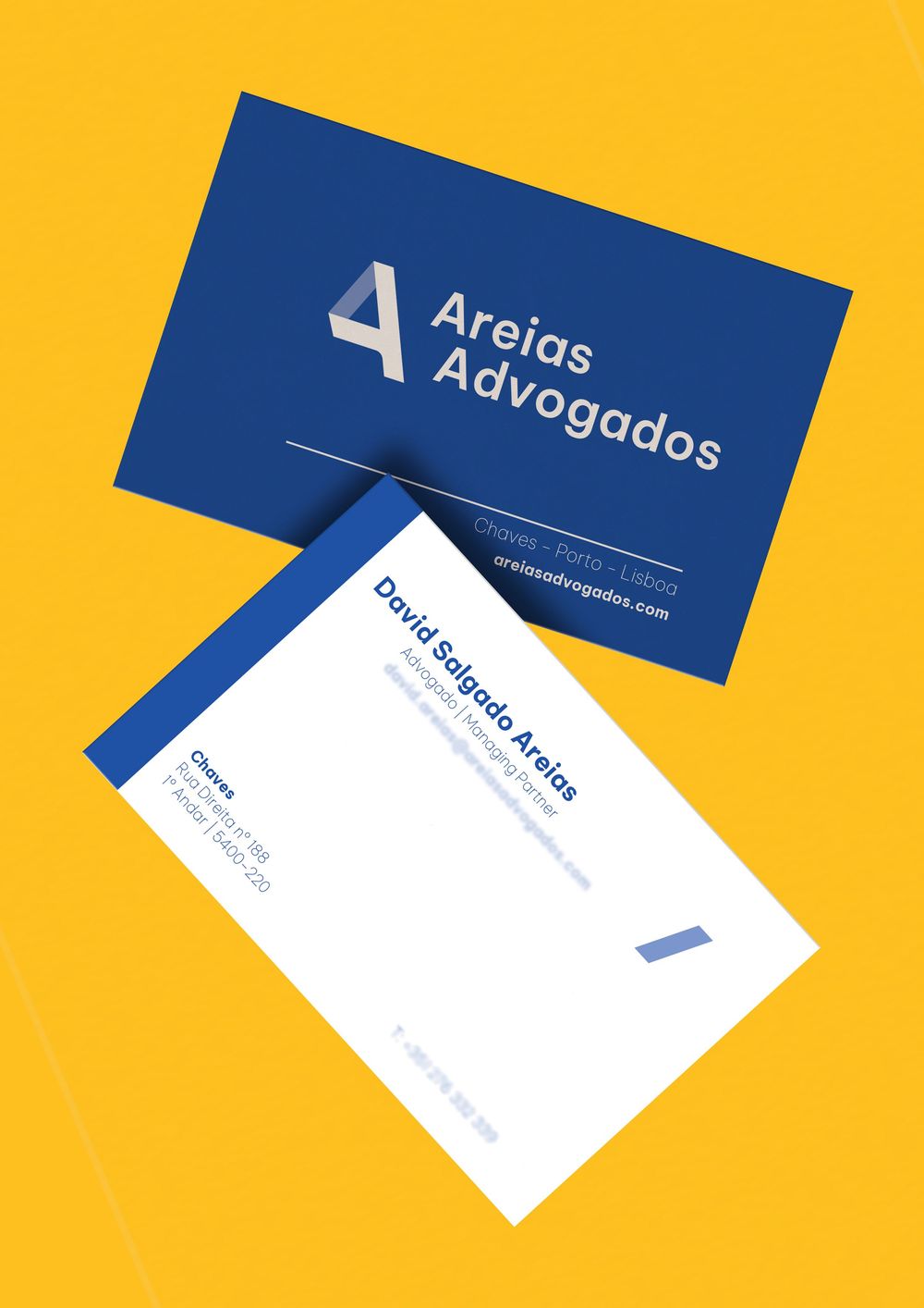 Business cards for law firm displayed on yellow background.