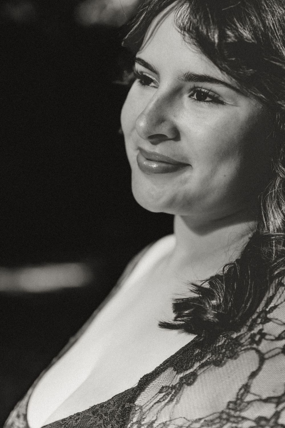 Dramatic black and white close-up portrait featuring lace details.