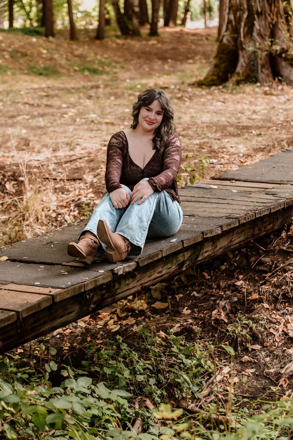 Autumn portrait on a wooden walkway wearing brown lace and denim.
