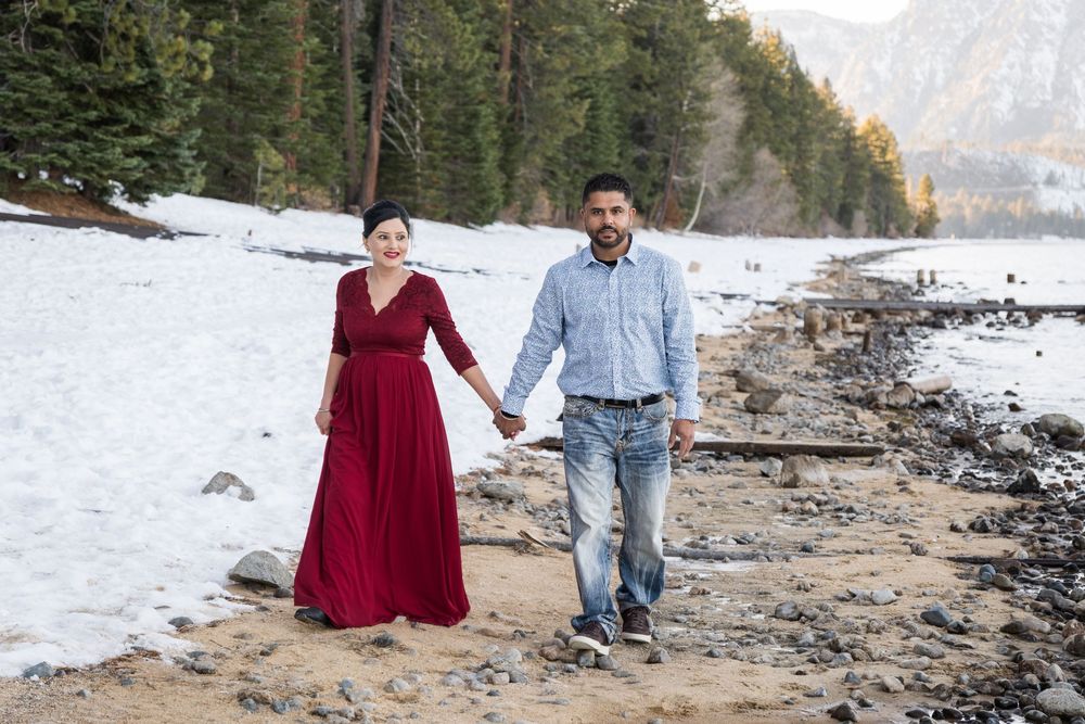 A romantic winter engagement photo series with a couple posing along a snowy mountain shoreline.