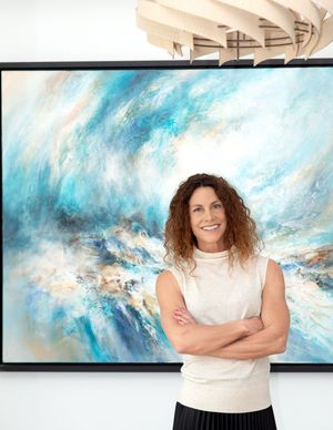 Professional portraits in front of a large abstract blue and white artwork.