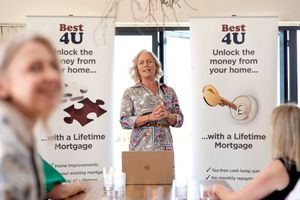 A row of blurred promotional marketing banners displayed on a wall with text about mortgage services.