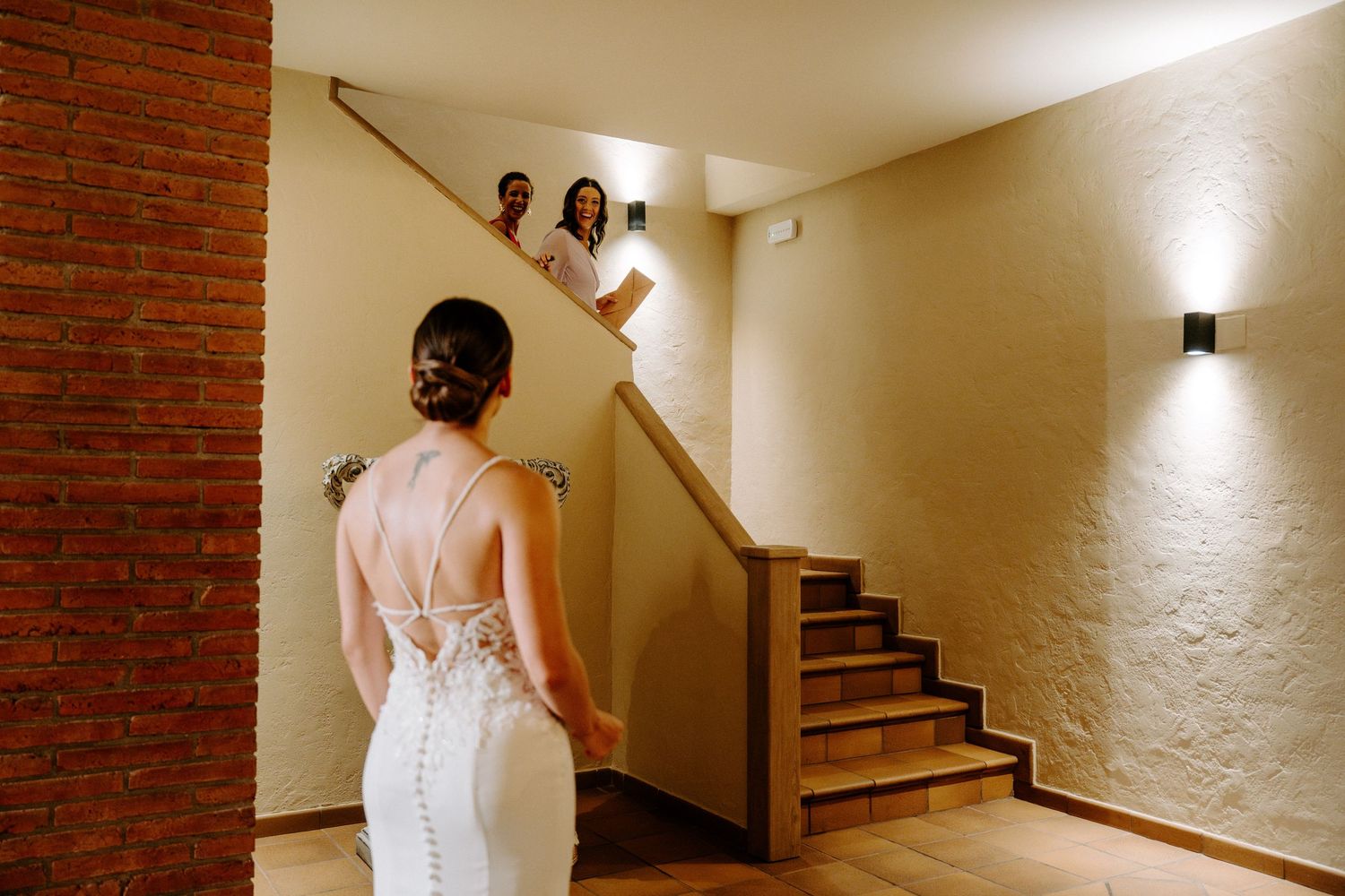 Bridal portrait session in elegant hallway with exposed brick and warm lighting.