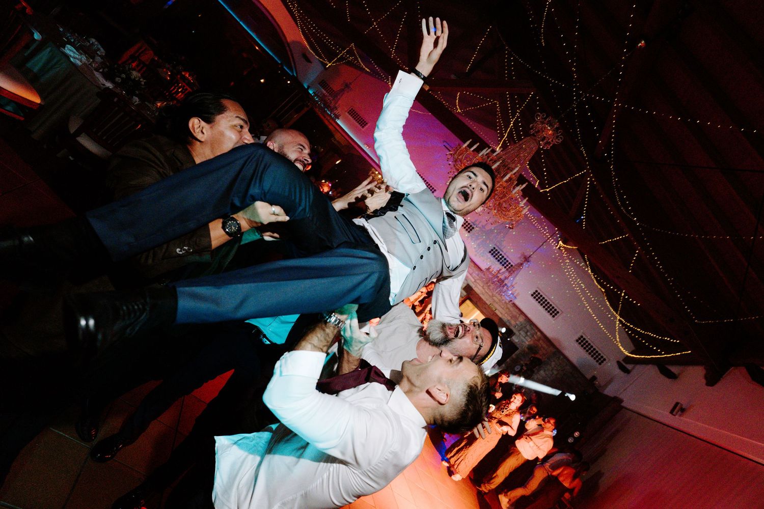 Energetic party scene with dancers silhouetted against colorful lighting effects.