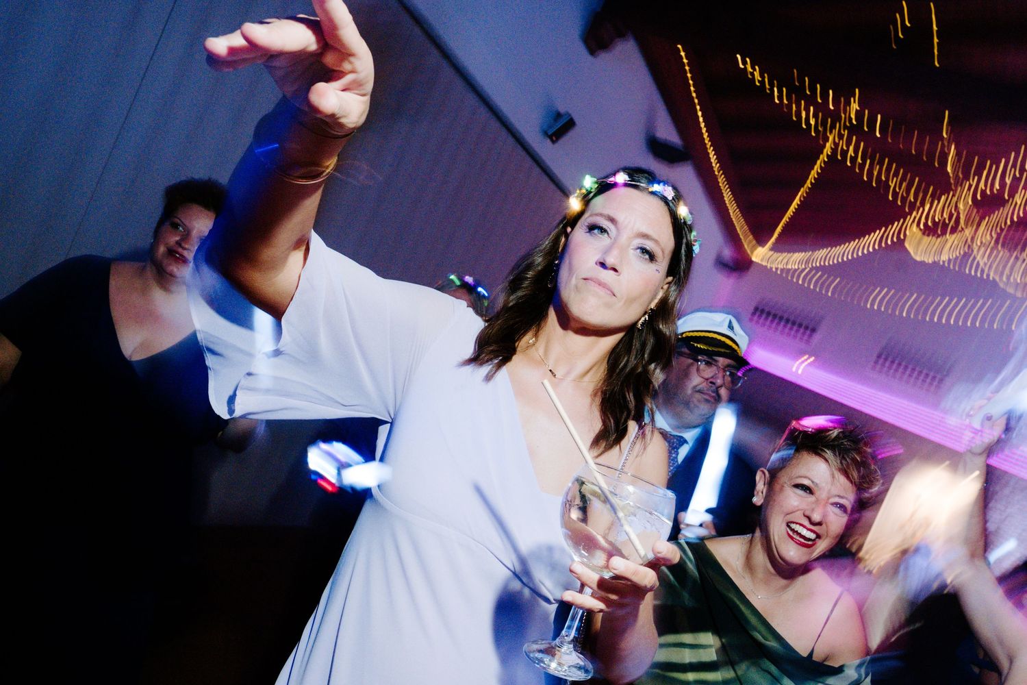 Wedding celebration captured with artistic motion blur and purple lighting effects.