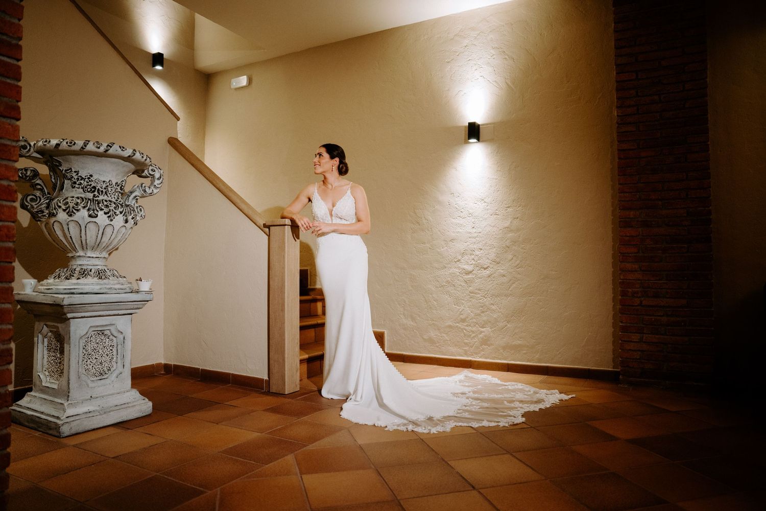 Elegant bridal portraits in minimalist hallway with architectural details and soft lighting.