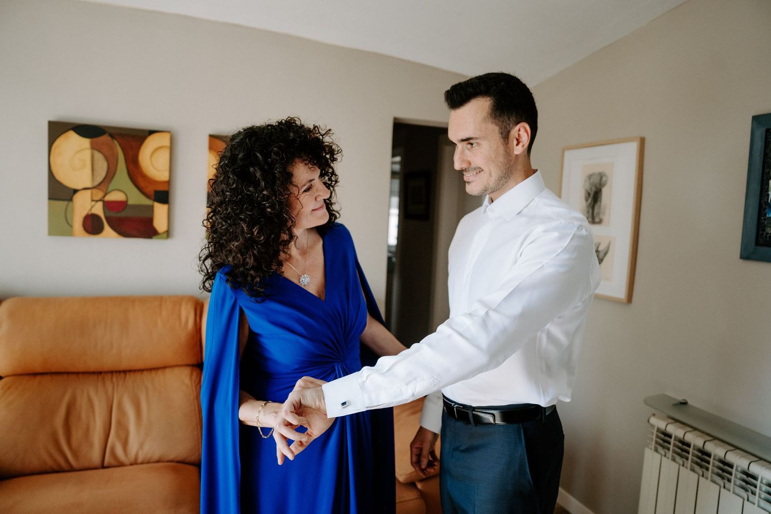 Couple in formal attire dancing and embracing in an intimate indoor setting.