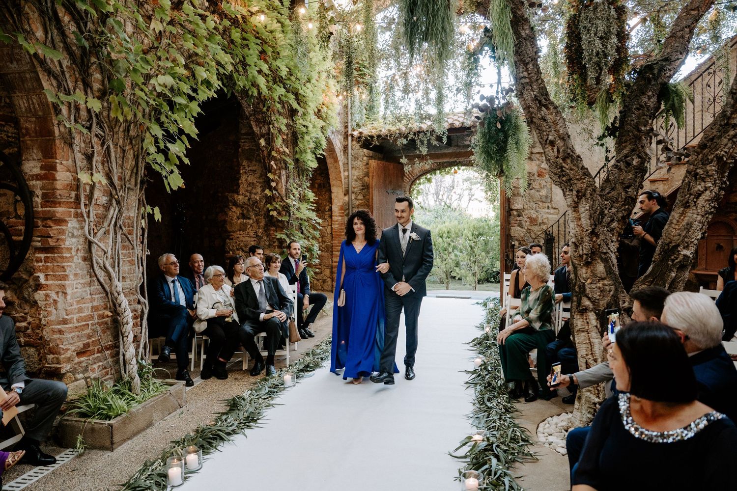 Natural light streams through stone archways at an elegant wedding venue.