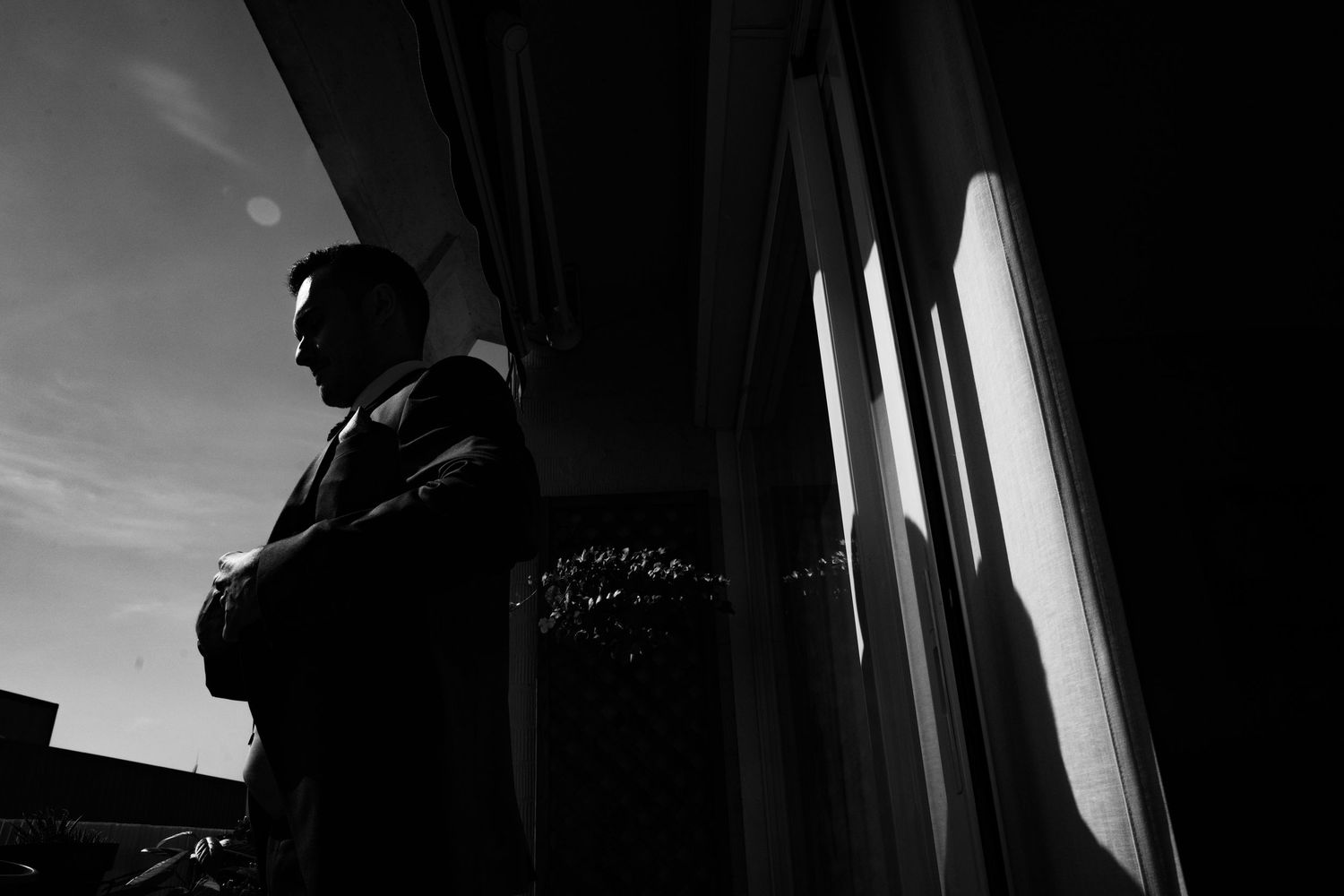Dramatic silhouette shots through window frames and doorways.