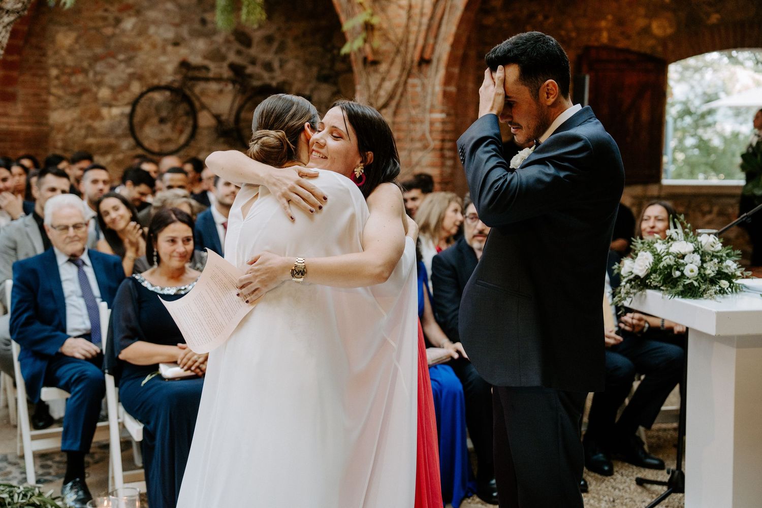 Intimate outdoor wedding ceremony moments captured against brick and ivy backdrop.