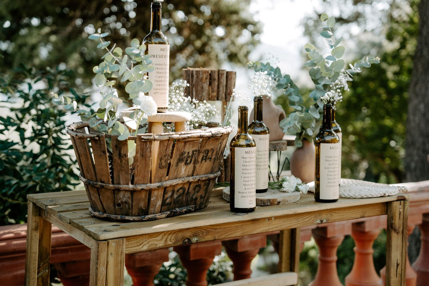 Rustic outdoor wedding decor with white flowers and wooden accents.