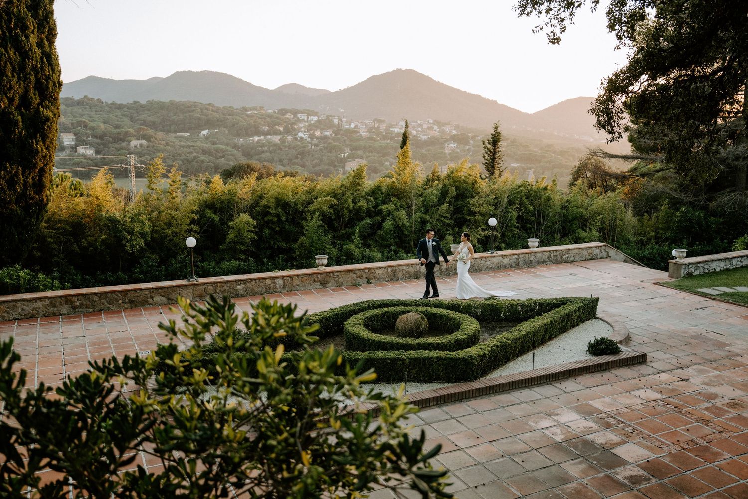 Elegant garden courtyard with mountain views featuring a classic fountain and manicured landscaping.