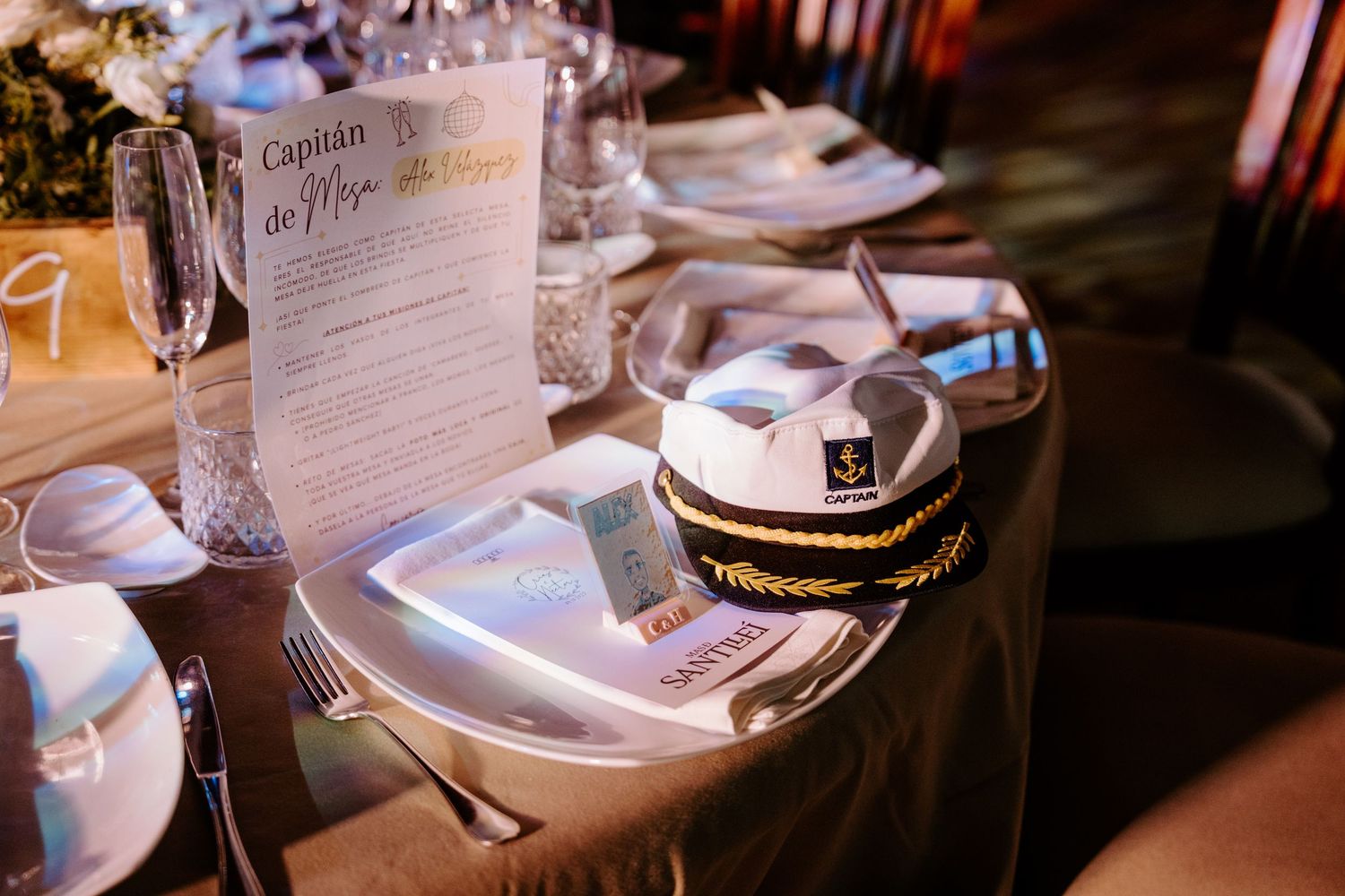 Wedding reception place setting with menu card and nautical themed details.