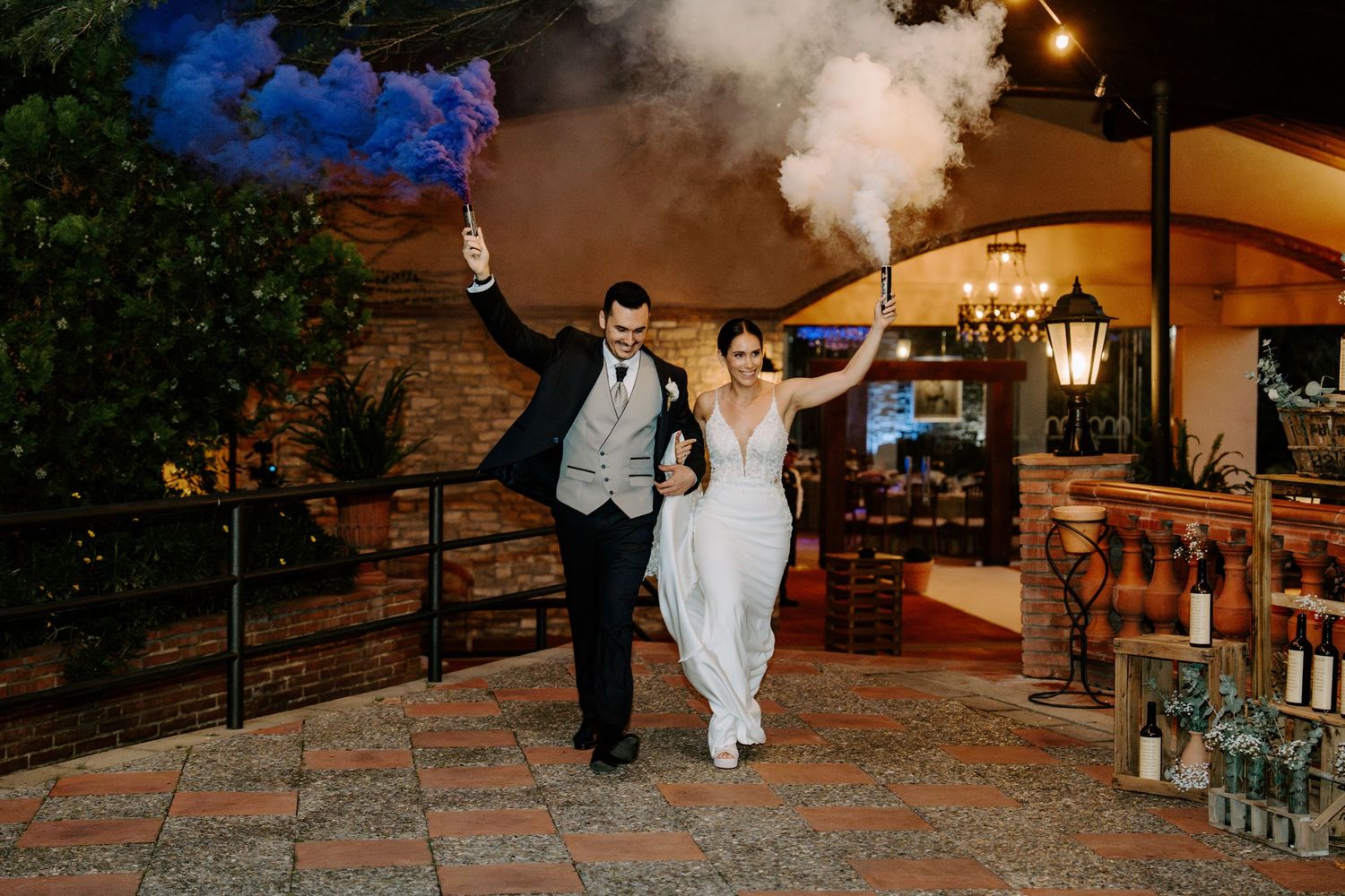 Wedding celebration at night with smoke effects and outdoor lighting.