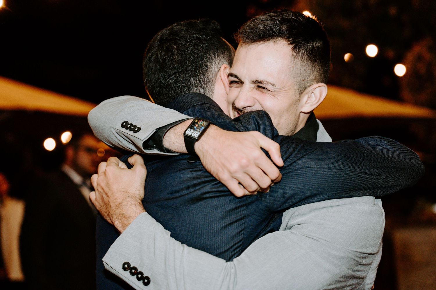Emotional moments shared between wedding guests during reception celebrations.
