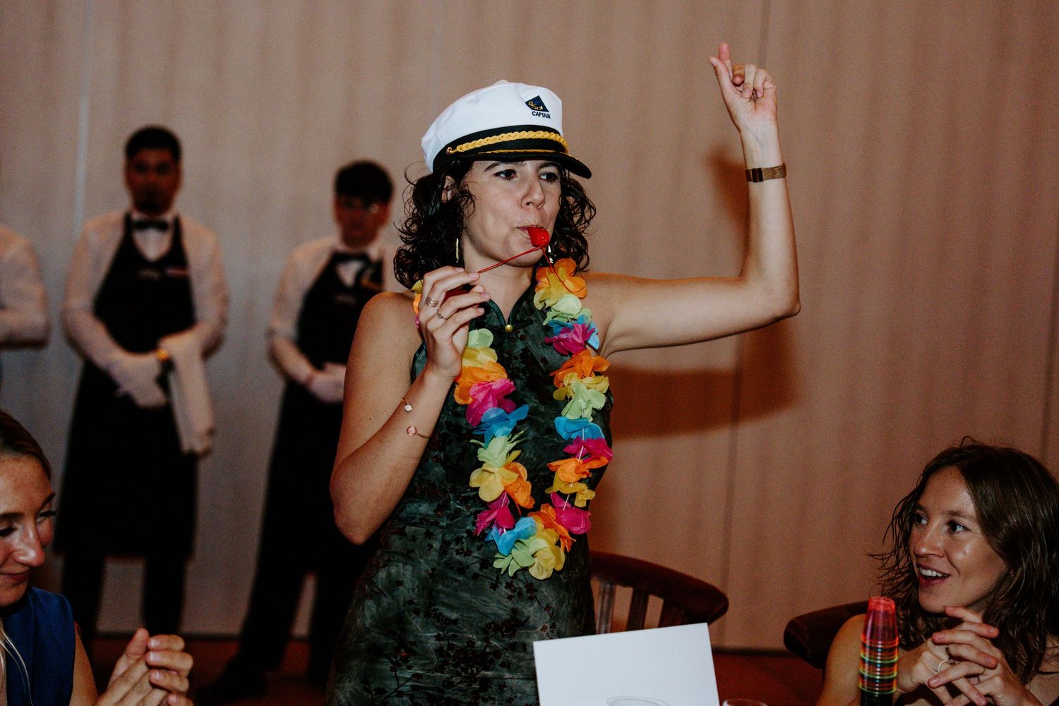 Wedding reception dance party with guests celebrating in colorful attire.