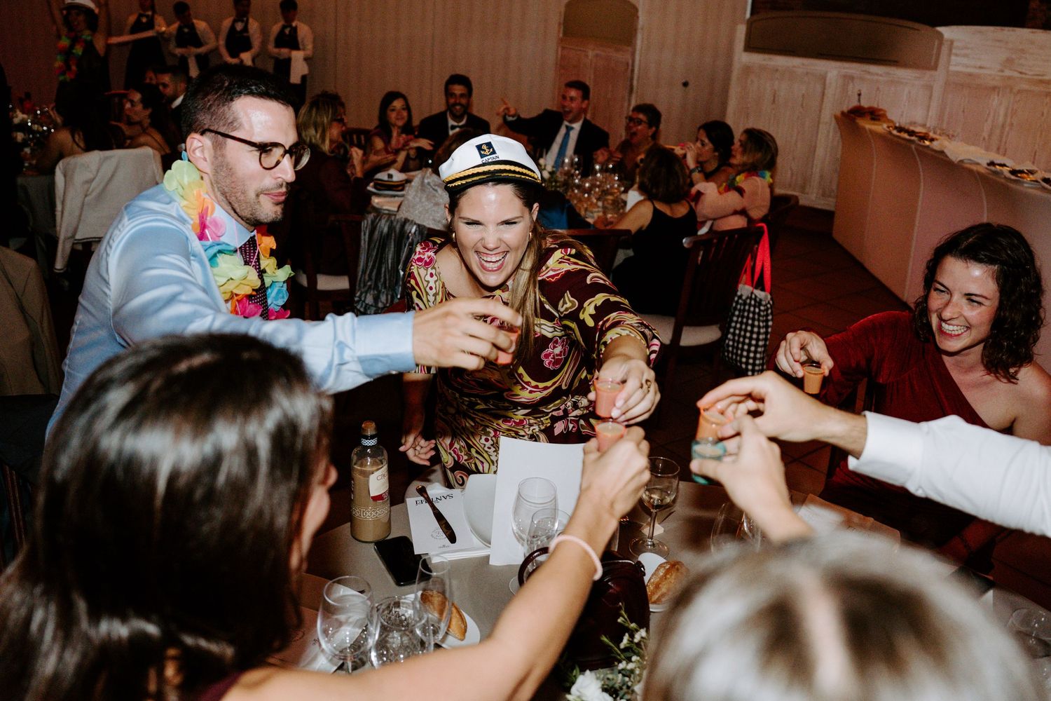 Lively dance floor scene at wedding reception with guests celebrating.