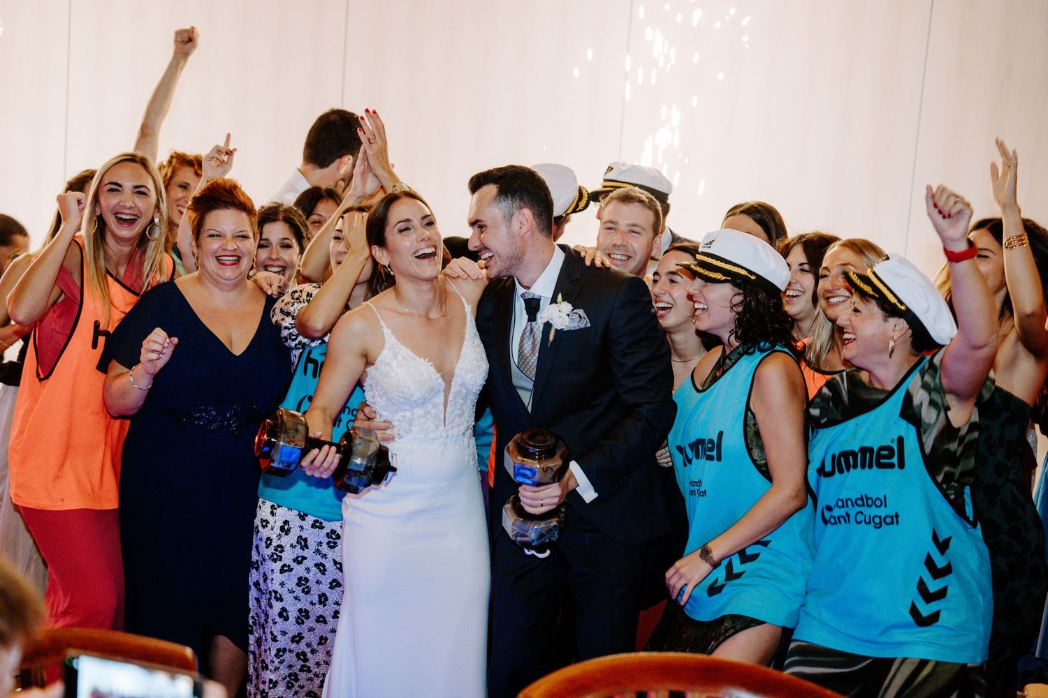 Lively wedding reception dance floor filled with celebrating guests.