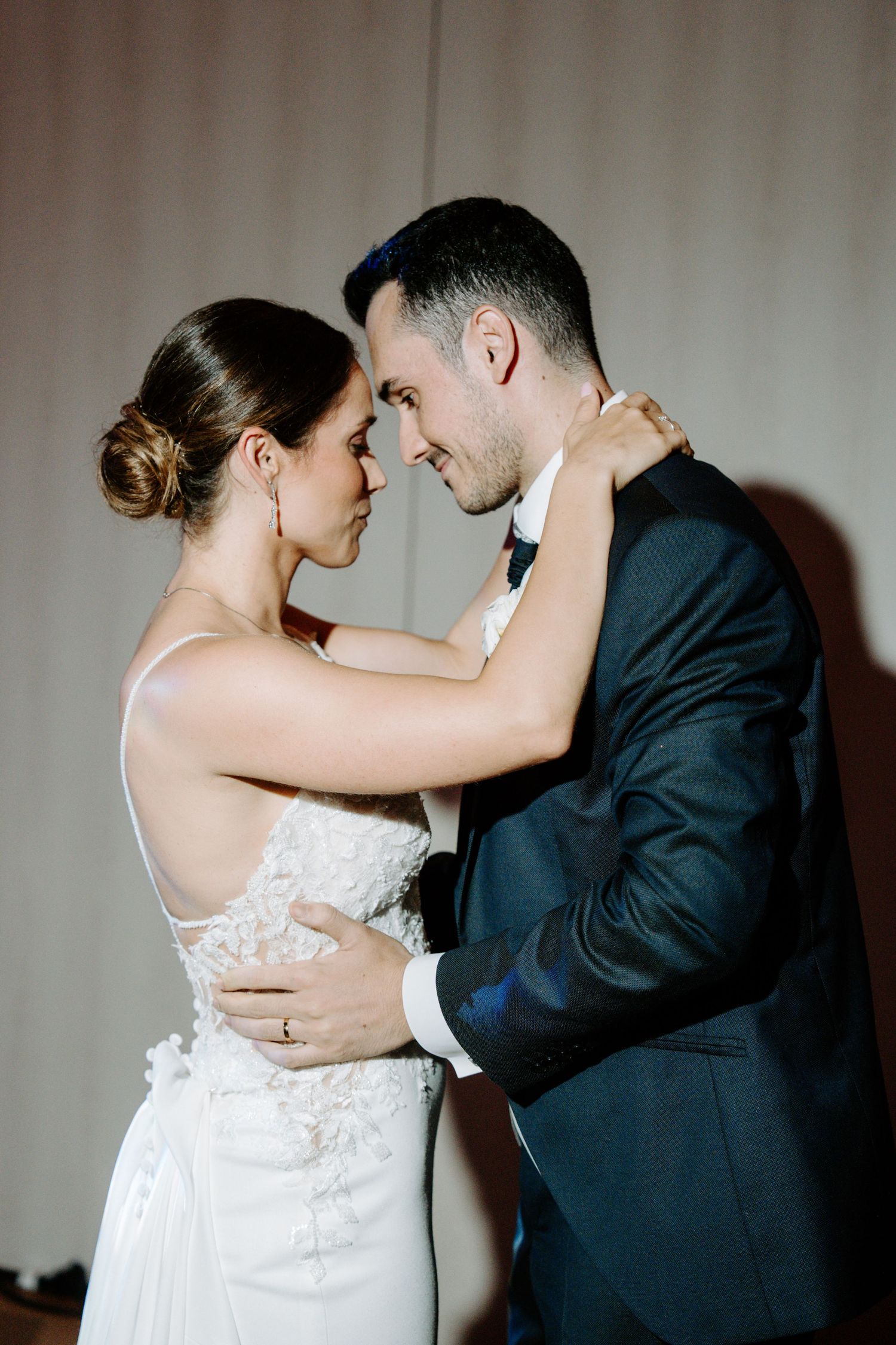 Intimate dance poses captured in dramatic studio lighting against a neutral wall.