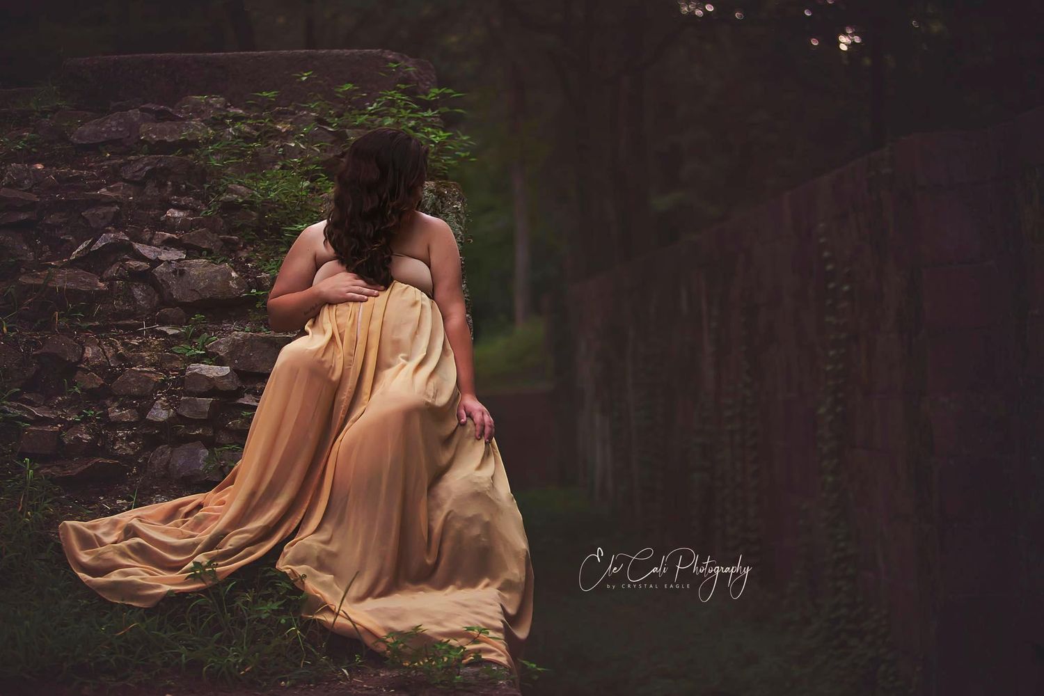 Flowing dress movement captured in dark forest setting.