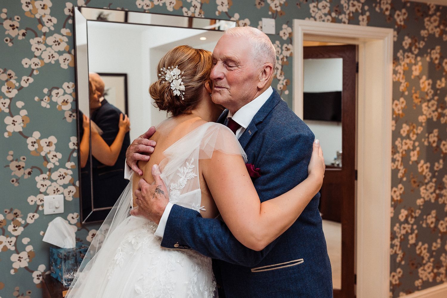 A couple shares a tender moment during their first dance at an elegant wedding reception.