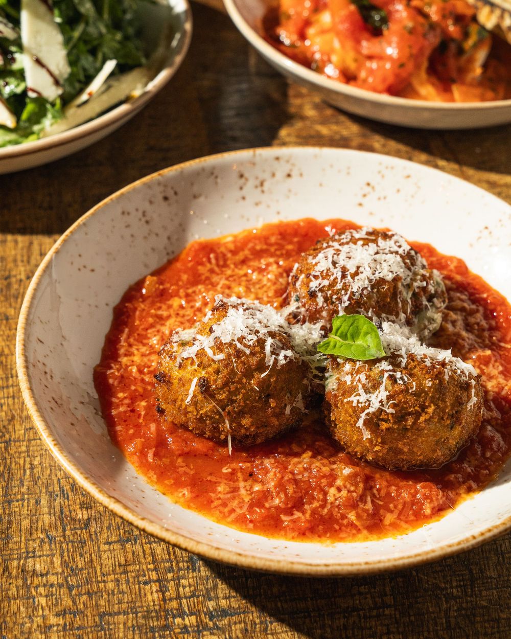 Italian meatballs in marinara sauce topped with grated parmesan and fresh basil.Mtlshutter photography