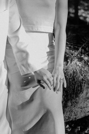 Detail shot of white wedding attire against natural lighting.