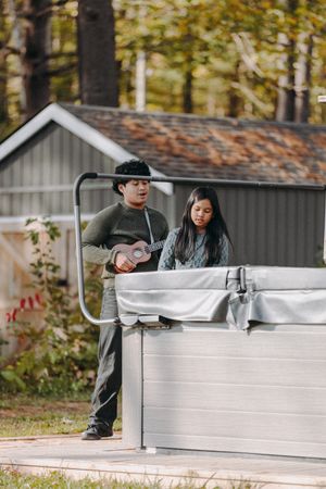 Hot tub or spa area at outdoor venue with rustic buildings in background.