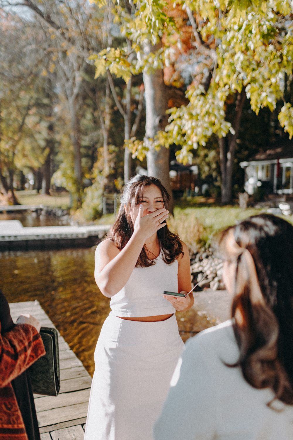 Emotional moment captured during an outdoor lakeside wedding ceremony.