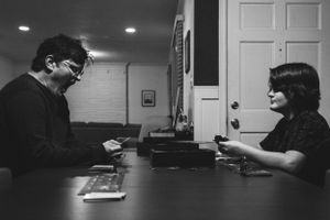 Memphis Family Portrait of father and son playing board game during Day in the Life session in Memphis Tennessee.