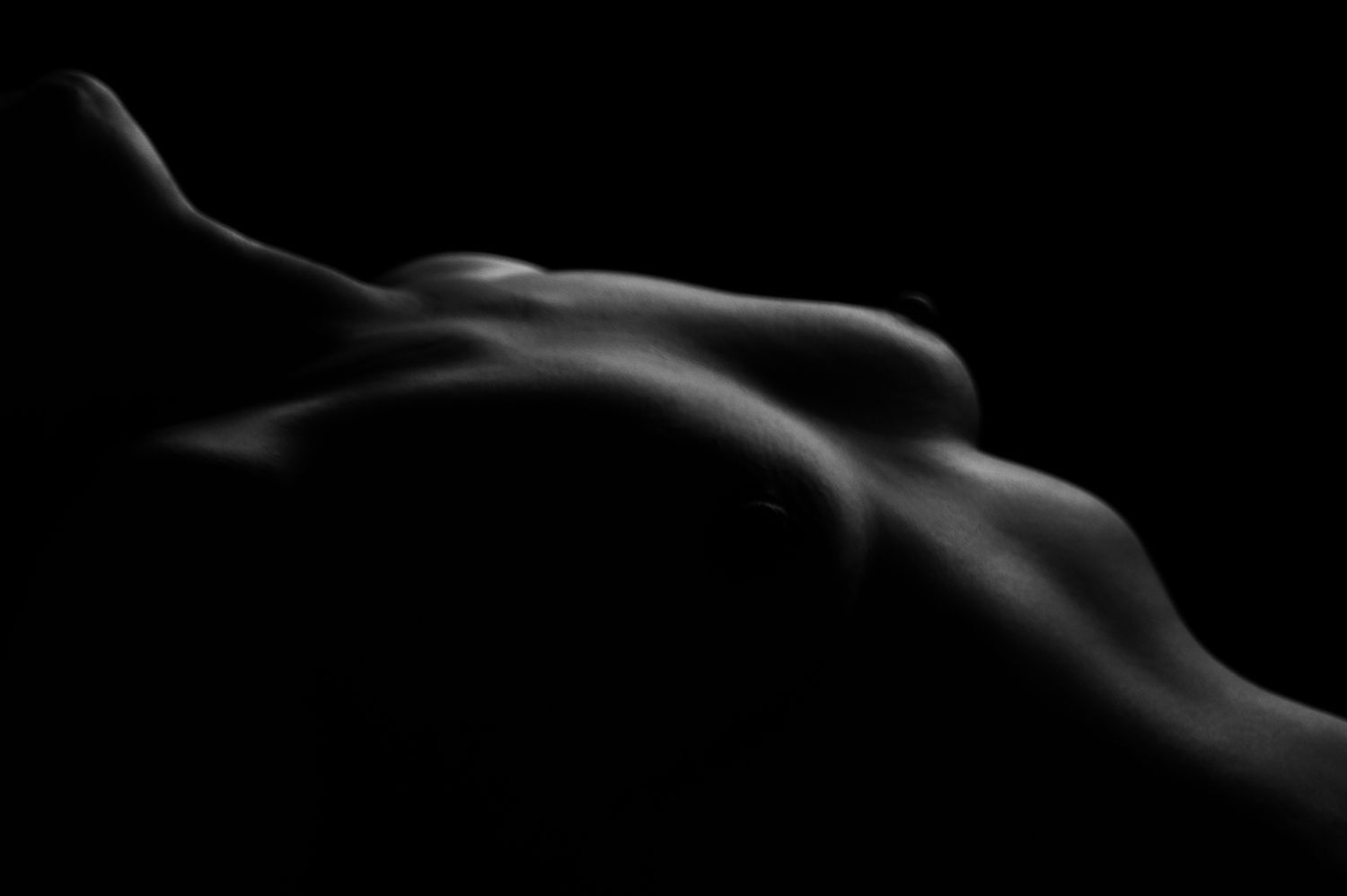 Abstract black and white smoke curves against dark background.