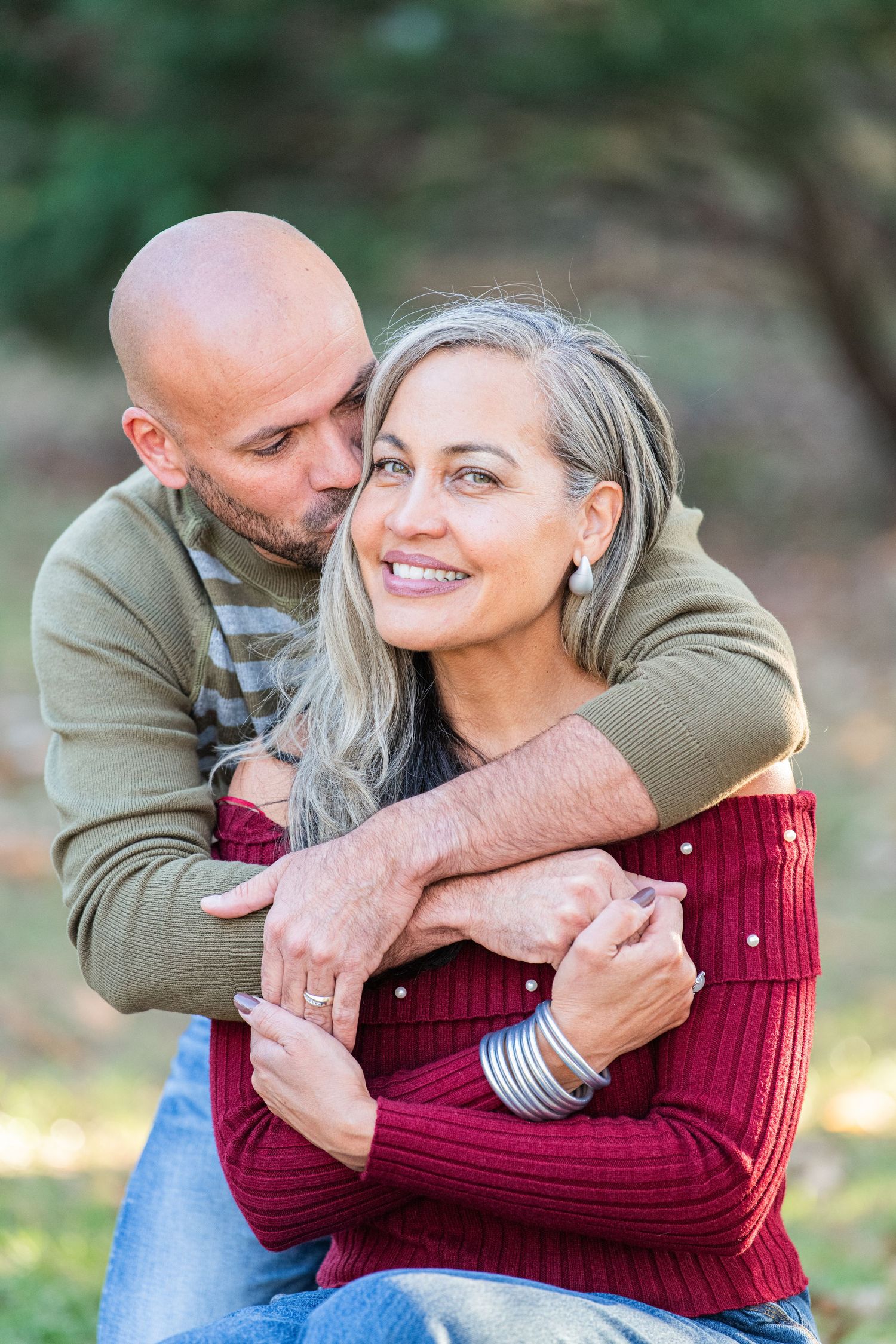 Sweet couple sharing a loving moment together, surrounded by a beautiful natural backdrop, capturing a tender and intimate memory.