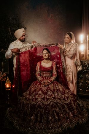 Traditional Indian wedding scene with ornate decor, elaborate attire, and warm candlelight creating an intimate atmosphere.