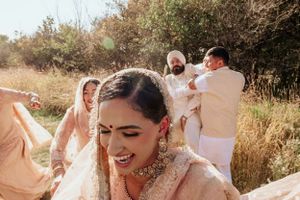 A joyful celebration captured in golden sunlit grass during an outdoor celebration.
