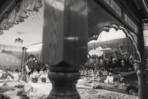 Black and white architectural photograph showing ornate arches and decorative details in a traditional setting.