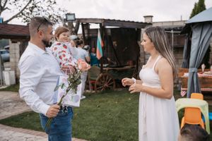 People gathering in a backyard for an outdoor celebration.