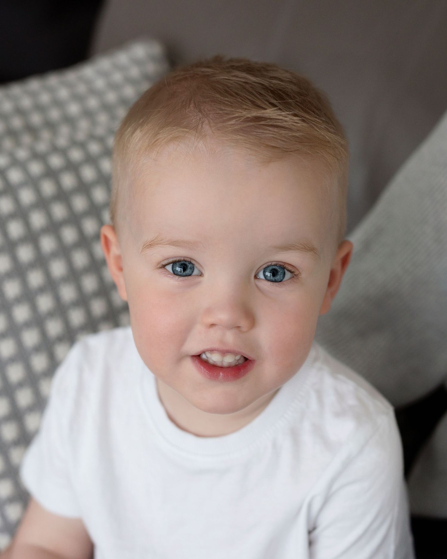 A series of close-up portraits of a beautiful boy with blonde hair and blue eyes.