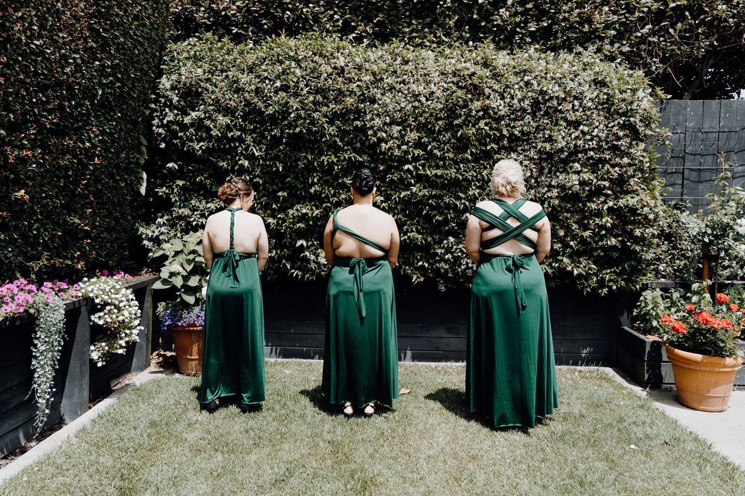 First Look with Bridesmaids in matching emerald green dresses, captured by Apertured Media Auckland Wedding Photographer.