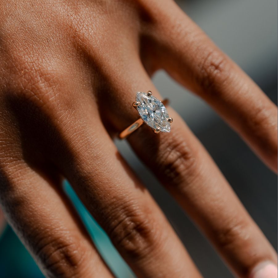 Close-up of a marquise-cut diamond engagement ring, showcasing intricate detail and timeless beauty.