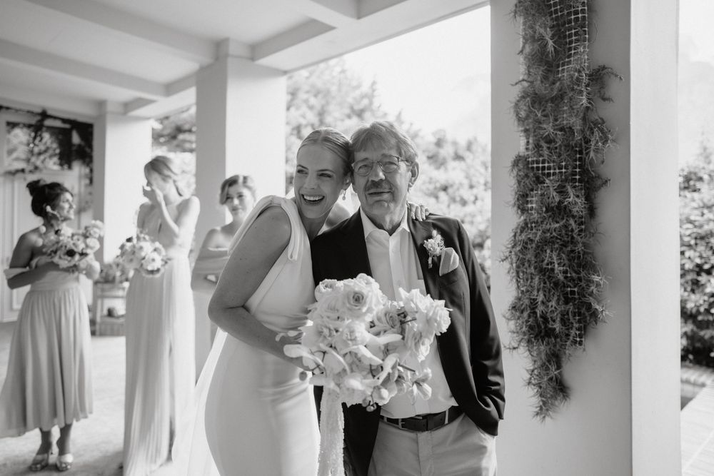 A black and white portrait capturing a joyful moment during a wedding celebration.