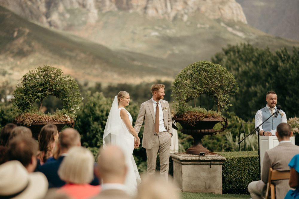 Wedding ceremony with a stunning mountain backdrop as the couple exchanges vows.