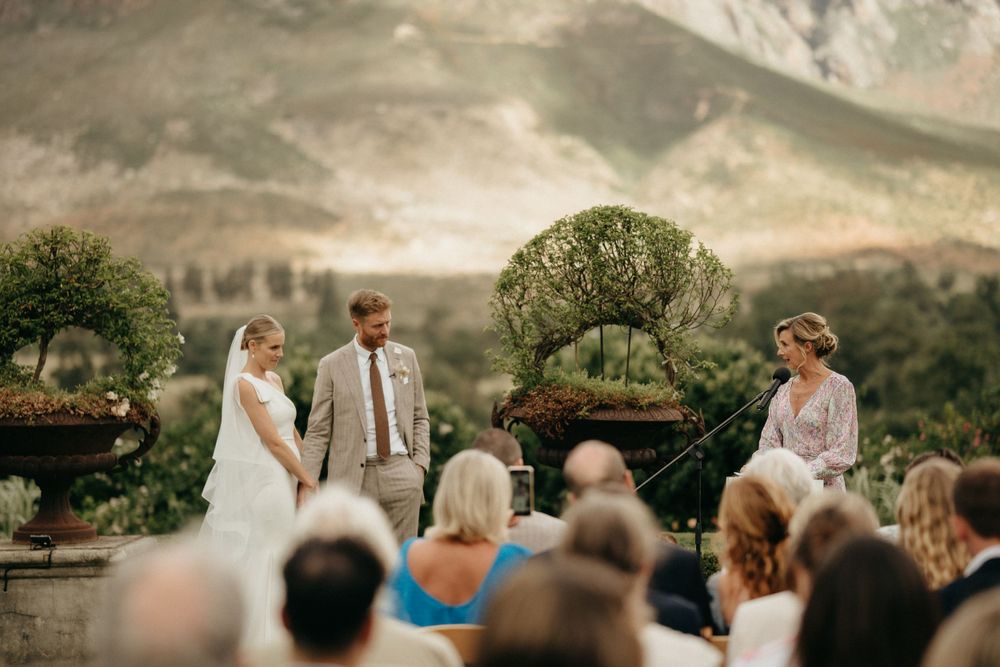 An intimate outdoor wedding ceremony with mountain views and natural landscaping.