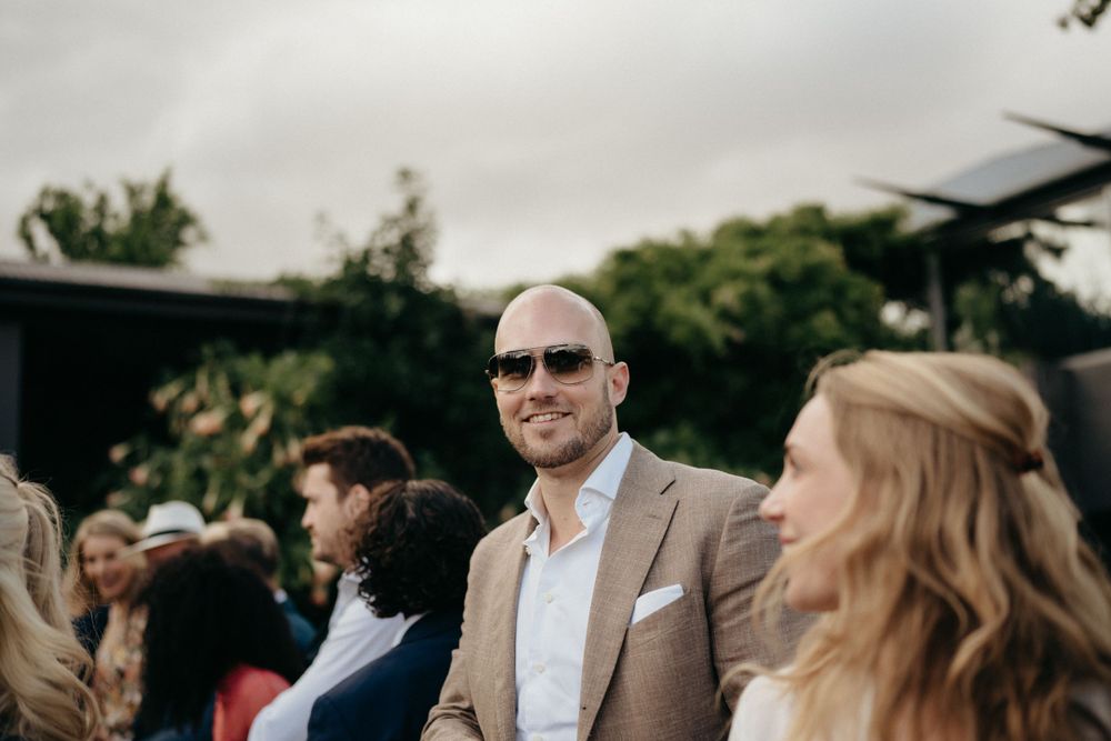 Wedding guests enjoying an outdoor reception on a cloudy day.