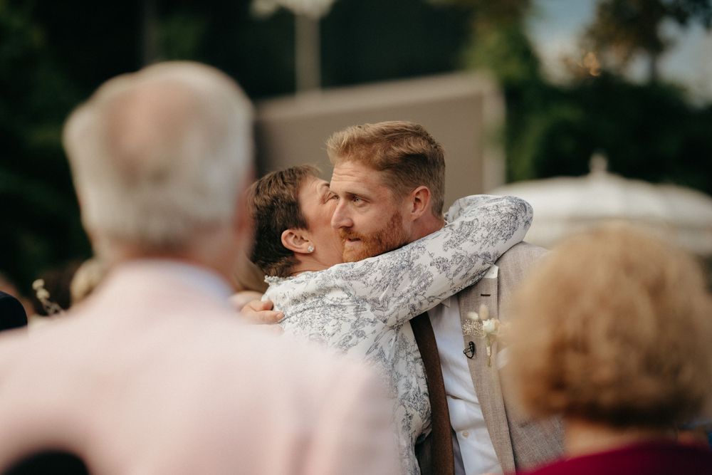 An intimate embrace captured during an emotional wedding ceremony moment.