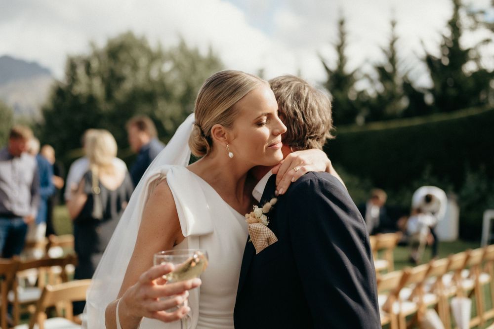 A tender moment during an outdoor mountain wedding celebration.