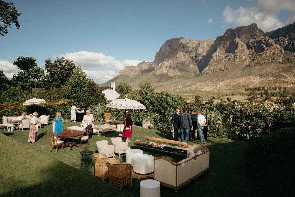 Outdoor wedding lounge area set against dramatic mountain landscape.
