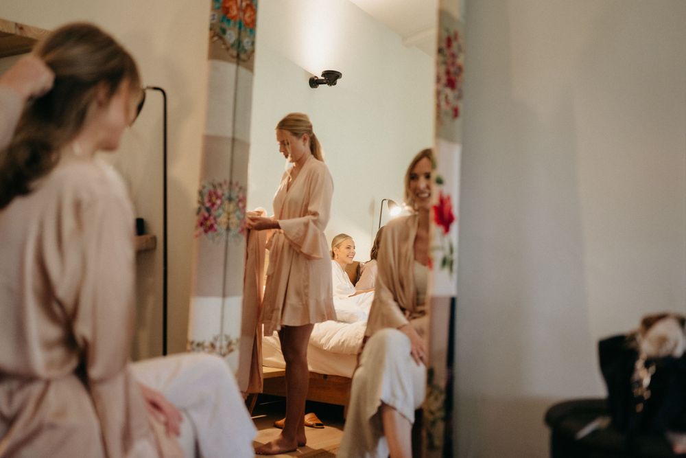 Behind-the-scenes moment of wedding preparations in a bright getting-ready room.